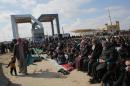 Palestinians gather in front of the Rafah border crossing point between southern the Gaza Strip and Egypt on January 16, 2015 to protest against the closure of the border