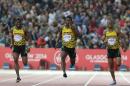 Rasheed Dwyer, centre of Jamaica, leads home a Jamaica 1, 2, 3, with Warren Weir, right, who placed second and Jason Livermore place 3rd in the men's 200 meter race at Hampden Park Stadium during the Commonwealth Games 2014 in Glasgow, Scotland, Thursday July 31, 2014. Dwyer won the gold medal winning the race.(AP Photo/Peter Morrison)