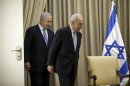 Israeli President Peres walks with Israeli PM Netanyahu before a brief ceremony at the president's residence in Jerusalem