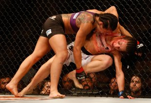 Claudia Gadelha (top) attempts a take down on Joanna Jedrzejczyk during UFC Fight Night in December 2014.  (Getty)