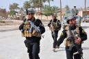 Members of the Iraqi Emergency Response Brigade patrol streets on June 24, 2014 in the western city of Ramadi in the Anbar province, where government forces fight against anti-government militants