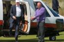 Donald Trump (left) arrives for a tour of Trump International Golf Links, north of Aberdeen, in Scotland, on June 25, 2016
