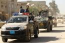 Security forces patrol a street in the city of Benghazi on June 25, 2014