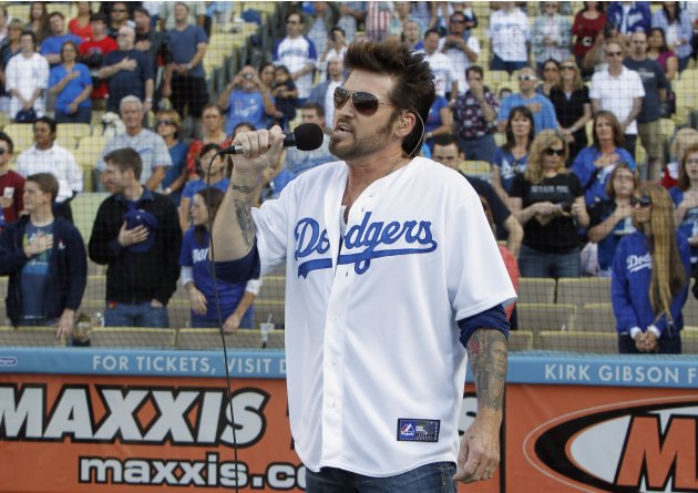 Country singer Billy Ray Cyrus sings the national anthem prior to the Los Angeles Dodgers playing against the Cincinnati Reds during their MLB baseball game in Los Angeles