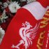 A football scarf lies with floral tributes at the Hillsborough memorial outside Liverpool Football Club's Anfield stadium