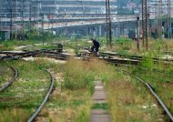 A railway worker operates a switch at Belgrade's Central railway station on August 29, 2013. The railray line from the Serbian capital to the Montenegrin port of Bar, once a pride of Yugoslavia's network, was designed for a speed of up to 120 kilometres per hour when it was completed in 1976. But now some of its parts have to be driven four to five time slower by ailing infrastructure