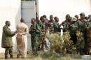 Mutinous soldiers arrive to speak with Ivory Coast's Minister of Defense Alain-Richard Donwahi in Bouake, Ivory Coast