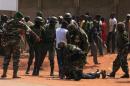 African Union peacekeeping mission to Central African Republic personnel control a fighting crowd near the airport in the capital Bangui