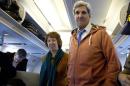U.S. Secretary of State John Kerry, right, and EU foreign policy chief Catherine Ashton, left, visit the media seating area of Kerry's aircraft as it sits on the tarmac at Geneva International airport before leaving for London, Sunday, Nov. 24, 2013, in Geneva, Switzerland. A deal has been reached between six world powers and Iran that calls on Tehran to limit its nuclear activities in return for sanctions relief, the French and Iranian foreign ministers said early Sunday. (AP Photo/Carolyn Kaster, Pool)
