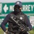 A federal policeman guards the area where dozens of bodies, some of them mutilated, were found on a highway connecting the northern Mexican metropolis of Monterrey to the U.S. border found in the town of San Juan near the city of Monterrey, Mexico,  Sunday, May 13, 2012. (AP Photo/Christian Palma)