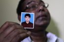 Bangladeshi Quazi Ahsanullah displays a photograph of his son Quazi Mohammad Rezwanul Ahsan Nafis as he weeps in his home in the Jatrabari neighborhood in north Dhaka, Bangladesh, Thursday, Oct. 18, 2012. The FBI arrested 21-year-old Nafis on Wednesday after he tried to detonate a fake 1,000-pound (454-kilogram) car bomb, according to a criminal complaint. His family said Thursday that Nafis was incapable of such actions. (AP Photo/A.M. Ahad)