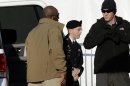 Army Pfc. Bradley Manning, second from right, steps out of a security vehicle as he is escorted into a courthouse in Fort Meade, Md., Thursday, Nov. 29, 2012, for a pretrial hearing. Manning is charged with aiding the enemy by causing hundreds of thousands of classified documents to be published on the secret-sharing website WikiLeaks. (AP Photo/Patrick Semansky)