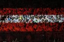 Spectators are illuminated with the colours of the Austrian flag during the opening ceremony of the World Alpine Skiing Championships in Schladming