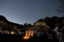 FILE - In this March 10, 2008 file photo, people watch as Mayan indian priests participate in a ceremony while one holds up a crystal skull at the Mayan ruins of Palenque, Mexico. There is a legend that the ancient Maya possessed 13 crystal skulls which, when united, hold the power of saving the Earth. Only a year is left before Dec. 21, 2012, when some believe the Maya predicted the end of the world. While some doomsday theorists may suggest putting together survival kits, people in southeastern Mexico, the heart of Maya territory, plan to throw a yearlong celebration. And to make a profit while they party. (AP Photo/Alexandre Meneghini)