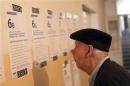 A man reads balloting instructions before casting his vote at a polling station in Kosovo's town of Mitrovica