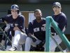 New York Yankees manager Joe Girardi, right, watches from the dugout along side Eduardo Nunez, center, and Jayson Nix during the second inning of an exhibition spring training baseball game against the Miami Marlins Friday, March 8, 2013, in Jupiter, Fla. The Marlins won 6-1. (AP Photo/Jeff Roberson)