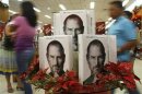 Customers walk past a display of the biography of Steve Jobs, sold at a bookstore in Quezon City