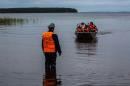 Emergency officers carry surviving children in a boat on Lake Syamozero in Russia's autonomic republic of Korelia on June 19, 2016