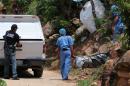 Forensic personnel load onto a van one of the ten bodies found in a mass grave in the tourist city of Acapulco, Mexico, on June 22, 2015