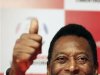 Pele gives a thumbs-up as he attends a news conference before the final match between Brazil's Corinthians and Argentina's Boca Juniors in Sao Paulo