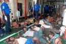 In this picture taken on Sunday, Feb. 17, 2013 and released by Sri Lankan Navy, Myanmar nationals rescued off Sri Lanka's eastern coast on Saturday lie on the floor at a hospital in Galle, Sri Lanka. The navy said it has rescued 32 Myanmar nationals whose wooden vessel began sinking while making a perilous journey to Australia. The group comprising 31 adult males and a boy had been at sea without food for 21 days when the navy rescued them after being informed by a local fishing boat. (AP Photo/Sri Lanka Navy) EDITORIAL USE ONLY