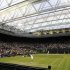 Ivan Ljubicic of Croatia serves to Andy Murray of Britain under the closed roof on Centre Court at the Wimbledon tennis championships in London