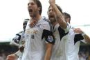 Swansea City's Miguel Michu (L) celebrates after scoring during the Premier League match against Crystal Palace in London on September 22, 2013