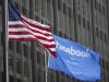 A flag announcing the IPO of Facebook flies next to the American flag outside the offices of J.P. Morgan in New York City