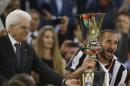 Juventus captain Giorgio Chiellini, right, receives the trophy from Italian President Sergio Mattrella at the end of the Italian Cup soccer final match between Lazio and Juventus at Rome's Olympic stadium, Wednesday, May 20, 2015. Juventus won 2 - 1. (AP Photo/Gregorio Borgia)