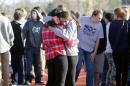 Students comfort each other at Arapahoe High School in Centennial, Colo., on Friday, Dec. 13, 2013, where a student shot at least one other student at a Colorado high school Friday before he apparently killed himself, authorities said. The shooter entered Arapahoe High School in a Denver suburb armed with a shotgun and looking for a teacher he identified by name, said Arapahoe County Sheriff Grayson Robinson. (AP Photo/Ed Andrieski)