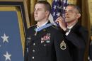 President Barack Obama bestows the Medal of Honor, the nation's highest decoration for battlefield valor, to Ryan M. Pitts, 28, of Nashua, NH, a former Army staff sergeant who fought off enemy fighters during one of the bloodiest battles of the Afghanistan war despite his own critical injuries, in the East Room of the White House in Washington, Monday, July 21, 2014. (AP Photo/J. Scott Applewhite)