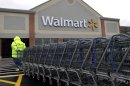In this Tuesday, Nov. 13, 2012 photo a worker pulls a line of shopping carts toward a Walmart store in North Kingstown, R.I. Wal-Mart Stores Inc. reported a 9 percent increase in net income for the third quarter, but revenue for the world's largest retailer fell below Wall Street forecasts as its low-income shoppers continue to grapple with an uncertain economy. (AP Photo/Steven Senne)