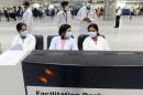 Indian medical officers wait at a counter to screen arriving air travellers at the Indira Gandhi International Airport in New Delhi on April 30, 2009