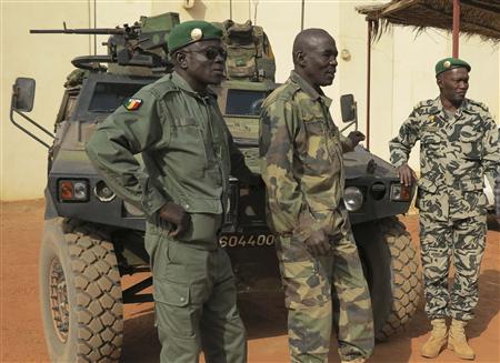 Malian military soldiers stand near an armoured vehicle that belongs to the French Army at the Malian military Command Post in Sevare, about 600 km (400 miles) northeast of the capital Bamako January 25, 2013. REUTERS/Adama Diarra