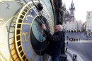 FILE - This Feb. 24, 2012 file photo shows Petr Skala performing his weekly maintenance of the famous Astronomical clock at the Old Town Square in Prague, Czech Republic. The clock was first installed in 1410, making it the third-oldest astronomical clock in the world and it is supposed to be the oldest one still working. (AP Photo/Petr David Josek)