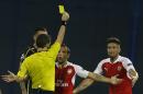Arsenal's Olivier Giroud, right, is shown a yellow card by the referee during a Champions League Group F soccer match between Dinamo Zagreb and Arsenal at the Maksimir Stadium in Zagreb, Croatia, Wednesday Sept. 16, 2015. (AP Photo/Darko Bandic)