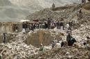 Yemenis inspect the rubble of destroyed houses in the village of Bani Matar on April 4, 2015