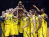 Michigan players celebrate with the trophy after defeating Kansas State, 71-57 in an NCAA college basketball game in the championship of the NIT Season Tip-Off at Madison Square Garden in New York, Friday, Nov. 23, 2012.  (AP Photo/Bill Kostroun)