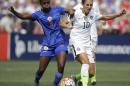 United States' Carli Lloyd, right and Haiti's Jennifer Limage fight for the ball in the first half during the US Women's World Cup victory tour, Sunday, Sept. 20, 2015, in Birmingham, Ala. (AP Photo/Brynn Anderson)