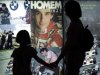 Visitors look at pictures of Brazilian Formula One driver Ayrton Senna displayed at the "Ayrton Senn..