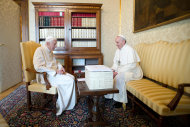 In this photo provided by the Vatican paper L'Osservatore Romano, Pope
 Francis, right, and Pope emeritus Benedict XVI meet in Castel Gandolfo Saturday, March 23, 2013. Pope Francis has traveled to Castel Gandolfo to have lunch with his predecessor Benedict XVI in a historic and potentially problematic melding of the papacies that has never before confronted the Catholic Church. The Vatican said the two popes embraced on the helipad. In the chapel where they prayed together, Benedict offered Francis the traditional kneeler used by the pope. Francis refused to take it alone, saying "We're brothers," and the two prayed together on the same one. (AP Photo/Osservatore Romano, HO)