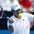 Isner of U.S. hits a return to compatriot Harrison during their men's singles match at the Sydney International tennis tournament