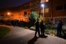 Police stand guard outside a block of residential flats as house to house enquiries are carried out in the area of South London on November 23, 2013 concerning the recent discovery of three women held captive for 30 years