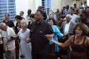 U.S. civil rights activist Jesse Jackson holds hands with believers during a religious service at the Martin Luther King Baptist congregation in Havana