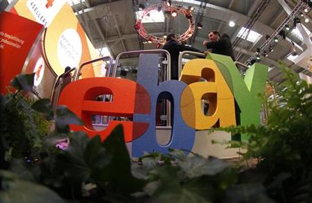 Visitors chat next to the Ebay logo at the CeBIT computer fair in Hanover March 2, 2011. REUTERS/Tobias Schwarz