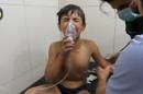 A file photo of a still image taken on September 7, 2016 from a video posted on social media said to be shot in Aleppo's Al Sukari on September 6, 2016, shows a boy breathing with an oxygen mask inside a hospital, after a suspected chlorine gas attack