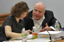 Michael Skakel, right, talks with Jessica Santos, one of his defense attorneys, during Skakel's appeal trial at Rockville Superior Court in Vernon, Conn., on Thursday, April 25, 2013. Skakel launched a barrage of criticism Thursday against the attorney who represented him at his murder trial, saying he failed to track down key witnesses while having fun and basking in the limelight. Skakel is serving 20 years to life in prison for the 1975 golf club bludgeoning of Martha Moxley in Greenwich when they were both 15 years old. Skakel argues trial attorney Michael Sherman got caught up in the limelight of the high-profile case and failed to prepare. (AP Photo/The Stamford Advocate, Jason Rearick, Pool)