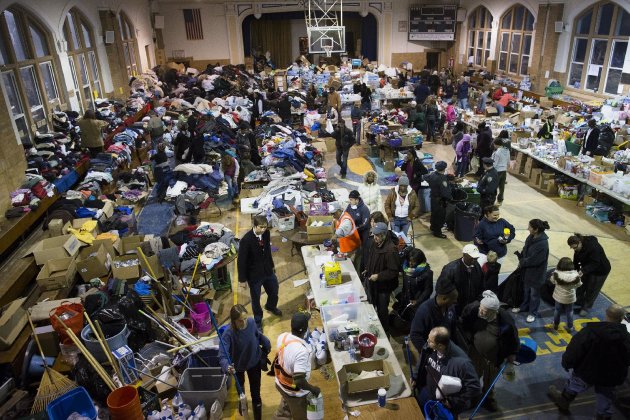 Donations are stored and distributed in the Saint Francis de Sales school gymnasium in the Rockaways, Saturday, Nov. 10, 2012, in the Queens borough of New York. Despite power returning to many neighborhoods in the metropolitan area after Superstorm Sandy crashed into the Eastern Seaboard, many residents of the Rockaways continue to live without power and heat due to damage caused by Sandy.(AP Photo/John Minchillo)