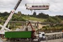 FILE - In this July 25, 2013 file photo, a derailed train car is lifted by a crane at the site of a train accident in Santiago de Compostela, Spain. A Spanish court official said Monday July 29, 2013 that judicial police would soon begin extracting information from the 