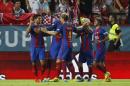 Barcelona's Luis Suarez, left, celebrates with teammates after scoring the first goal during the Spanish Super Cup first=leg soccer match, against Sevilla, at Ramon Sanchez-Pizjuan stadium in Seville, Spain, Sunday, Aug. 14, 2016. (AP Photo/Antonio Pizarro)